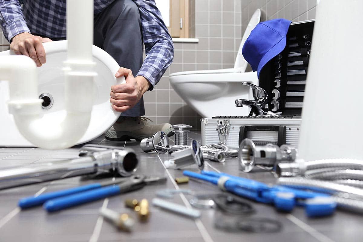 Plumber fixing sink